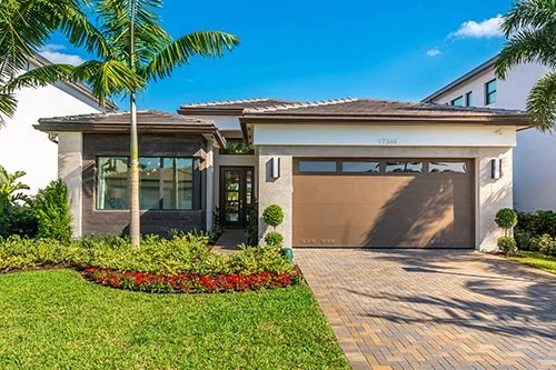Modern Florida home with palm trees and landscaped front yard